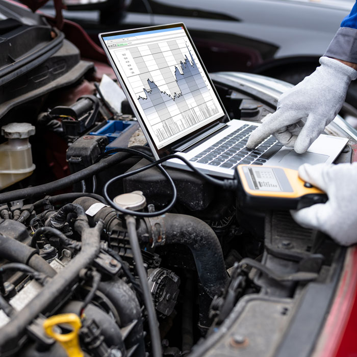 man using diagnostic tool on a car engine